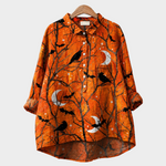 Blusa naranja con pájaros